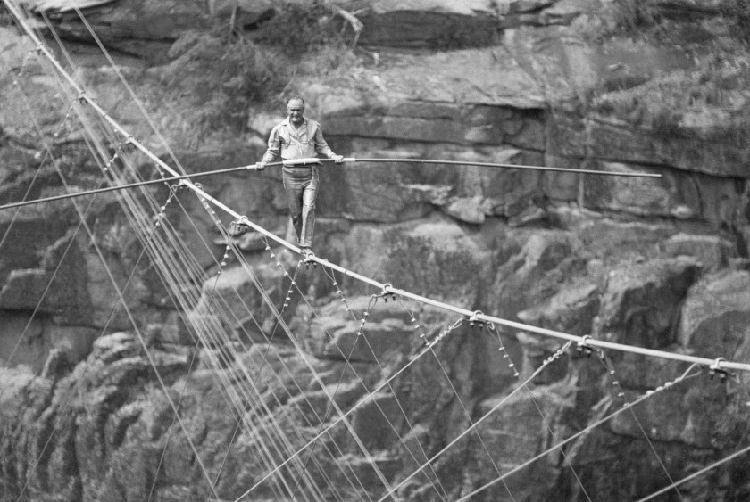 Karl Wallenda, patriarch of the Flying Wallendas tightrope troupe, walks a tightrope across the Tallulah Gorge, as an audience of 35,000 look on. (Bettmann / Contributor)