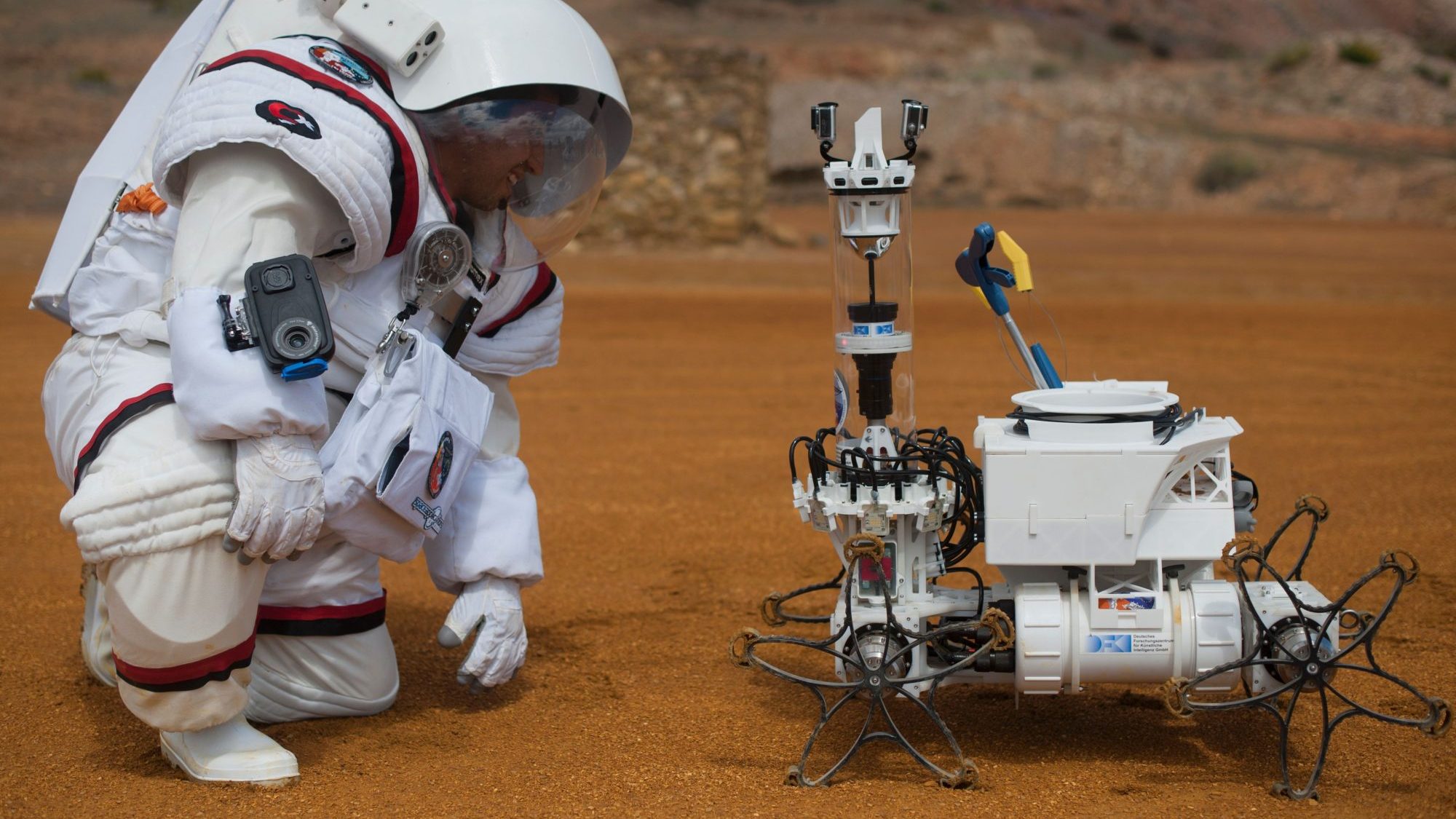 Colombian astronaut Diego Urbina tests the Gandolfi 2 spacesuit as he looks at 'Yemo' robot during the Moonwalk project's first Mars mission simulation in the southwestern Spanish town of Minas de Riotinto, Huelva province, on April 22, 2016. (Jorge Guerrero/AFP/Getty Images)