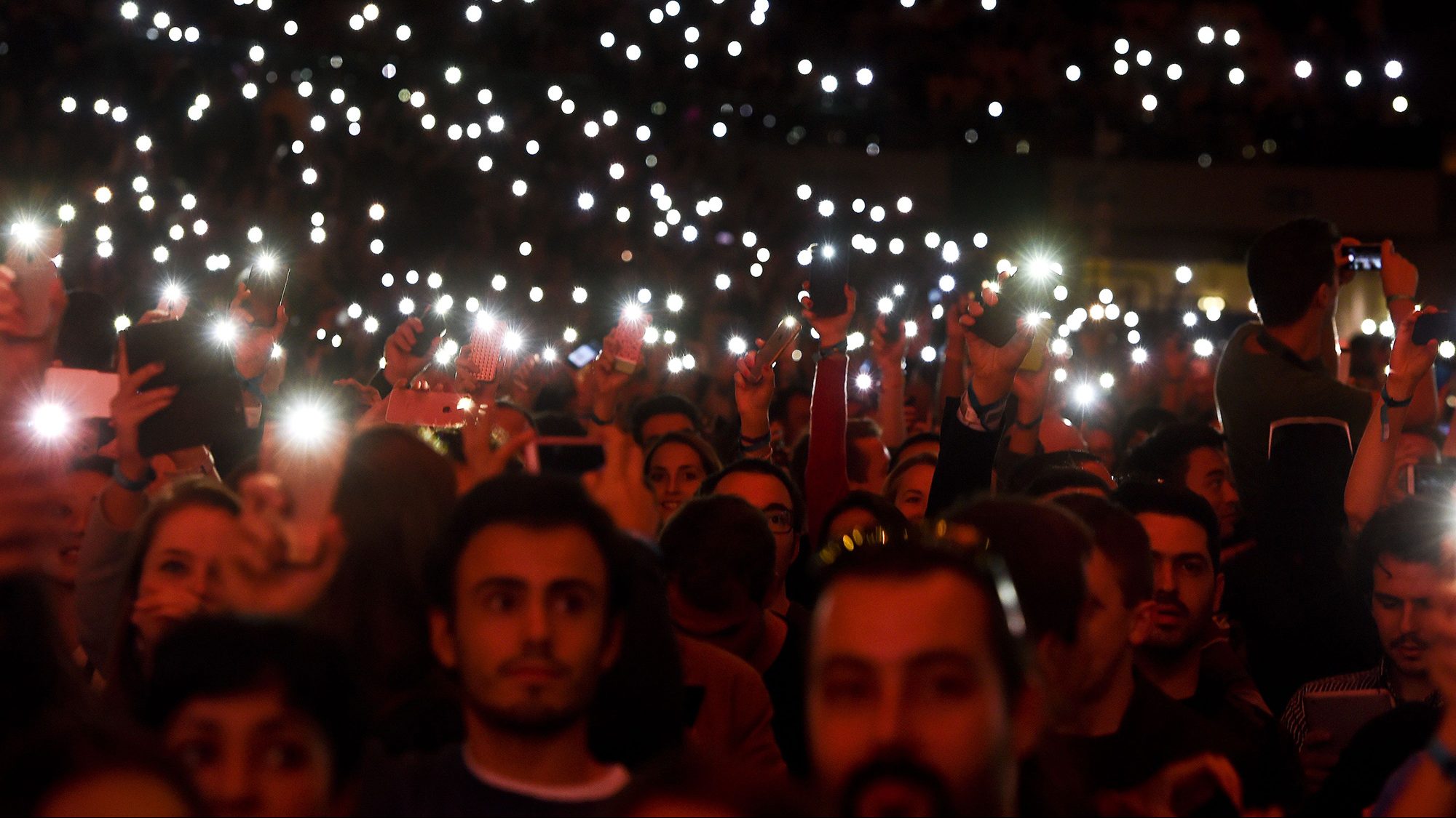 Web Summit's attendees light up the flash lights of their phones at the main stage during the Web Summit at Parque das Nacoes, in Lisbon on November 9, 2016.
Europe's largest tech event Web Summit will be held at Parque das Nacoes in Lisbon from November 7 to 10, 2016. (Patricia De Melo Moriera/AFP/Getty Images)