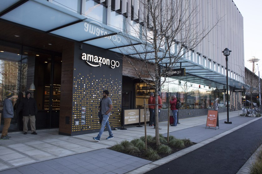 A pedestrian passes in front of the new Amazon Go grocery store in Seattle, Washington, U.S., on Tuesday, Dec. 6, 2016. Amazon.com Inc. unveiled technology that will let shoppers grab groceries without having to scan and pay for them -- in one stroke eliminating the checkout line. (David Ryder/Bloomberg via Getty Images)