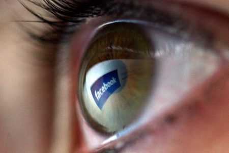 Facebook logo is reflected in the eye of a girl (Chris Jackson/Getty Images)