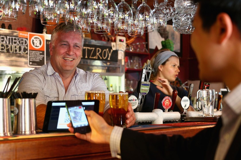 The Old Fitzroy Pub owner Garry Pasfield serves a customer using bitcoins on September 19, 2013 in Sydney, Australia. (Cameron Spencer/Getty Images)