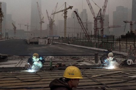 Chinese workers weld at a construction site in heavy pollution on November 29, 2014 in Beijing, China. United States President Barack Obama and China's president Xi Jinping agreed on a plan to limit carbon emissions by their countries, which are the world's two biggest polluters, at a summit in Beijing earlier this month.  (Kevin Frayer/Getty Images)