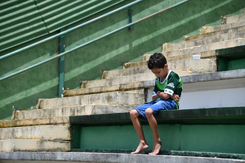 A boy sits alone on the stands during a tribute to the players of Brazilian team Chapecoense Real who were killed in a plane accident in the Colombian mountains, at the club's Arena Conda stadium in Chapeco, in the southern Brazilian state of Santa Catarina, on November 29, 2016. Chapecoense had risen from obscurity to make it to the Copa Sudamericana finals scheduled for Wednesday against Atletico Nacional of Colombia. (Nelson Almeida/AFP/Getty Images)