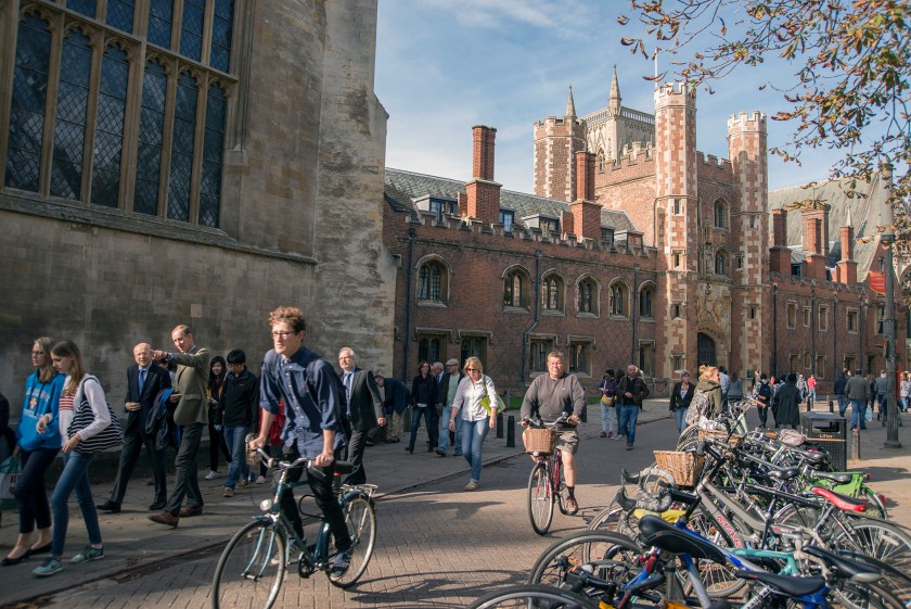 Cyclists and pedestrians move along Trinity Street past St Johns College, part of the University of Cambridge in Cambridge, U.K., on Sunday, Oct. 5, 2014. (Peter Kindersley/Bloomberg via Getty Images)