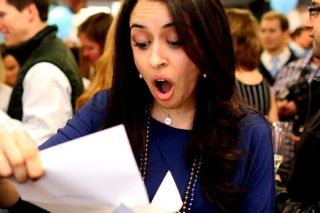 Fourth year medical students from Tufts University School of Medicine gather for what's known as Match Day to receive their envelopes telling them where they will do their residency training. Mina Khorashadi opens her acceptance letter, telling her she will be going to Stewart Carney Hospital for a one-year internship before moving to Anesthesiology at the University of California San Francisco. (Jonathan Wiggs/The Boston Globe via Getty Images)