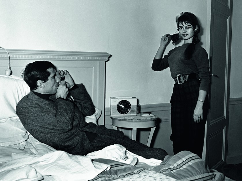 Brigitte Bardot being photographed by her husband in their room at the Hotel Negresco, in Nice during 1955. (Riviera Cocktail, Edward Quinn - Côte d'Azur Jet Set of the 1950s, Small Format Edition, to be published by teNeues)