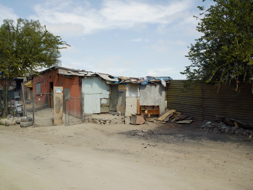 Home using border fence as a fourth wall in Colonia Libertad, Tijuana, Mexico in 2014. (Richard Misrach, Courtesy Fraenkel Gallery, Pace/MacGill Gallery, and Marc Selwyn Fine Art)