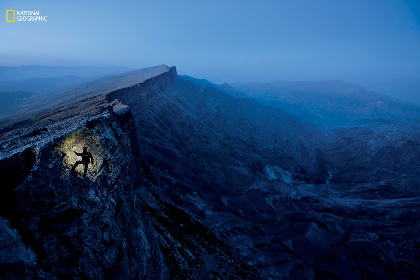 Writer Mark Synnott scales a cliff in Uzbekistan’s Boysuntov Range. Within this limestone wall lies a winding underworld. So far, eight missions have explored Dark Star. No one knows how far the cave extends. (Robbie Shone/National Geographic)