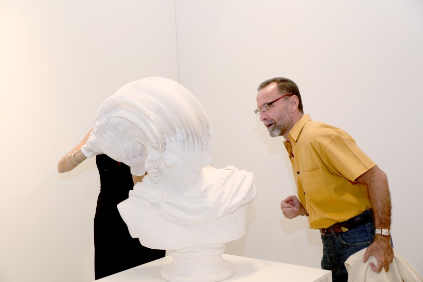 A guest enjoys the artwork by Li Hongbo on display attends the Art Miami 2016 VIP Preview at Art Miami Pavilion on November 29, 2016 in Miami, Florida. (Aaron Davidson/Getty Images for Art Miami)