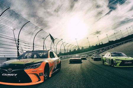 Martin Truex Jr., driver of the #78 Bass Pro Shops/TRACKER Boats Toyota Toyota, and Matt Kenseth, driver of the #20 Dollar General Toyota, lead the field at the start of the NASCAR Sprint Cup Series Go Bowling 400 at Kansas Speedway on May 7, 2016 in Kansas City, Kansas.  (Chris Graythen/Getty Images)