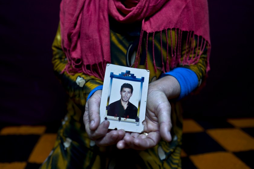 In this Tuesday, Jan. 24, 2017 photo, Heven Daood, 39, a Syrian refugee from Tell-Tawil in al-Hasaka, shows a photograph of her husband Reiad, 45, at her shelter in Ritsona refugee camp, Greece. "I have this photograph with me for the last 10 years, it is a very precious picture, my husband used to travel a lot for work and this image always remained close to my heart." Heven said. (AP Photo/Muhammed Muheisen)