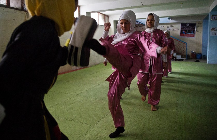 Shaolin martial arts students practice at their club in Kabul, Afghanistan, Tuesday, Jan. 25, 2017. When they aren’t training on the snow covered hills that surround Kabul, Azimi, teacher wearing black, trains her students in a grungy, dark club financed by a young cinema actor. (AP Photos/Massoud Hossaini)