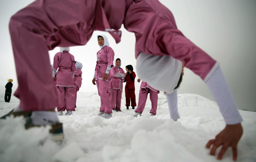 Shaolin martial arts students practice on a hilltop in the snow, in Kabul, Afghanistan, Tuesday, Jan. 25, 2017. The ten ethnic Hazara women are preparing for the day that Afghanistan can send its women’s team to the Shaolin world championship in China. (AP Photos/Massoud Hossaini)