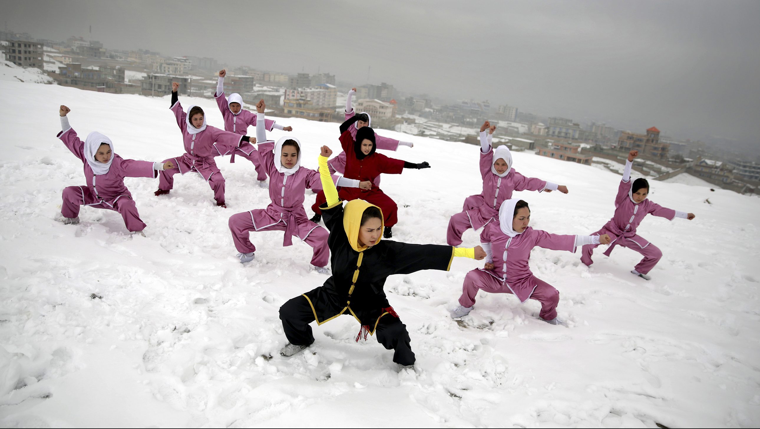 Shaolin martial arts students follow their trainer, Sima Azimi, 20, in black, during a training session on a hilltop in Kabul, Afghanistan, Tuesday, Jan. 25, 2017. Sima Azimi, 20, who is originally from Jaghuri in central Afghanistan, trains nine students in the martial arts to prepare for Olympic competitions, but also to protect themselves on the streets of Kabul, where women are routinely harassed. (AP Photos/Massoud Hossaini)