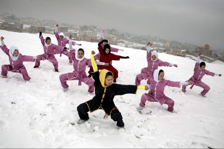 Shaolin martial arts students follow their trainer, Sima Azimi, 20, in black, during a training session on a hilltop in Kabul, Afghanistan, Tuesday, Jan. 25, 2017. Sima Azimi, 20, who is originally from Jaghuri in central Afghanistan, trains nine students in the martial arts to prepare for Olympic competitions, but also to protect themselves on the streets of Kabul, where women are routinely harassed. (AP Photos/Massoud Hossaini)