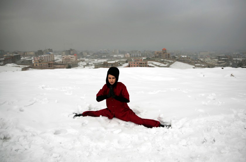 A Shaolin martial arts student practices the splits on a hilltop in Kabul, Afghanistan, Tuesday, Jan. 25, 2017. In religiously conservative Afghanistan, girls are often discouraged from aggressive sports. (AP Photos/Massoud Hossaini)