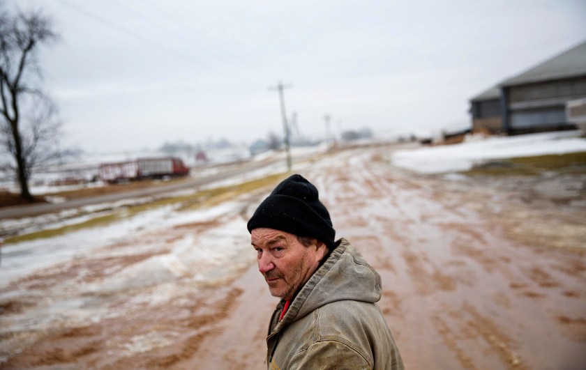 Bernard Moravits walks on his farm in Bloomington, Wis., Thursday, Jan. 19, 2017. Moravits works on his 10,000 acres at least 12 hours every day, and usually a lot longer. He diversified to minimize risk and now farm dairy cows and beef cows, corn, beans, alfalfa. The price of milk and other agricultural goods has plummeted, and it's getting harder to keep things running, he said. Change is what he looked to Obama for and now expects from Trump. (AP Photo/David Goldman)