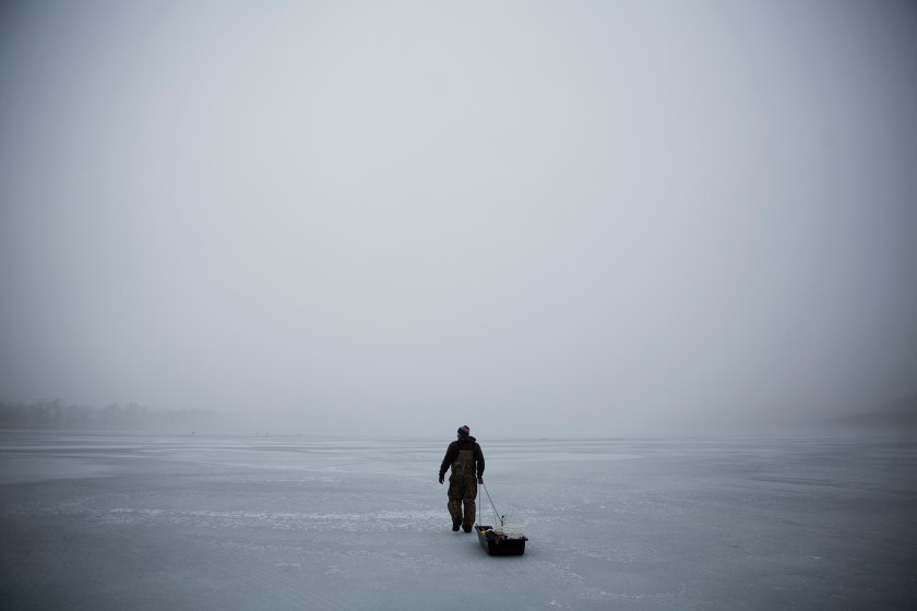 An ice fisherman walks out on a frozen portion of the Mississippi River in Prairie du Chien, Wis., Friday, Jan. 20, 2017. In this corner of middle America, in this one, small slice of the nation that sent Trump to Washington, they are watching and they are waiting, their hopes pinned on his promised economic renaissance. And if four years from now the change he pledged hasn't found them here, the people of Crawford County might change again to someone else. (AP Photo/David Goldman)