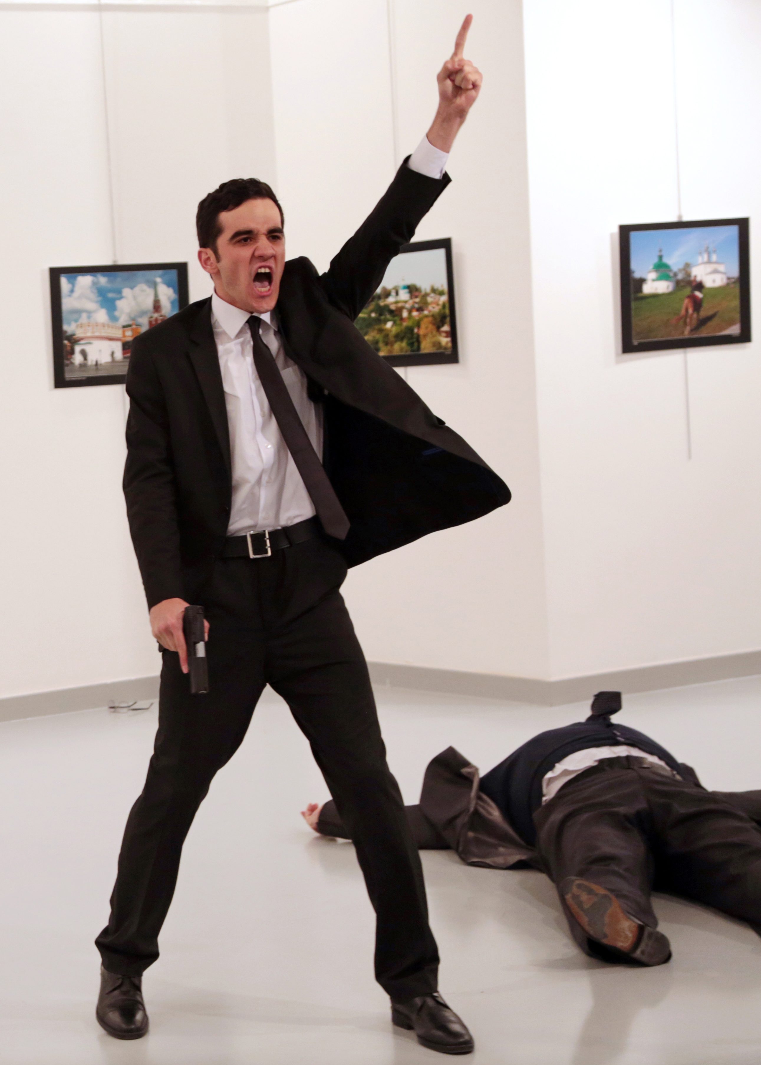 World Press Photo of the Year: Mevlut Mert Altintas shouts after shooting Andrei Karlov, right, the Russian ambassador to Turkey, at an art gallery in Ankara, Turkey, Monday, Dec. 19, 2016.  (AP Photo/Burhan Ozbilici)