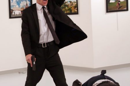 World Press Photo of the Year: Mevlut Mert Altintas shouts after shooting Andrei Karlov, right, the Russian ambassador to Turkey, at an art gallery in Ankara, Turkey, Monday, Dec. 19, 2016.  (AP Photo/Burhan Ozbilici)