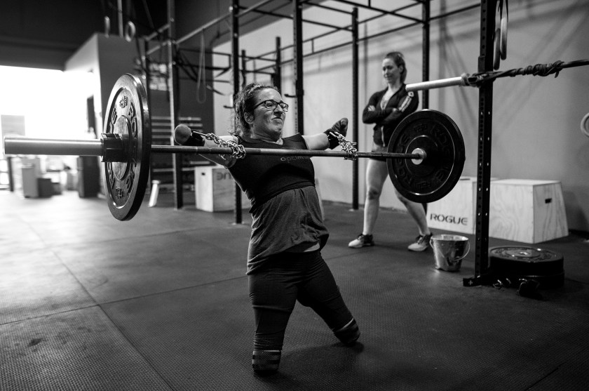 Sports - Third Prize, Stories: With the aid of chains purchased at the hardware store and deadlift straps, Lindsay performs snatches under the watchful eye of coach and co-owner of CrossFit OnSide Jenny Jeffries in Halifax, Nova Scotia, Canada on July 8, 2016. "It's been an important relationship for me", says Jeffries, who was admittedly affected by her mother's disabilities following a car accident. "How could it not - seeing Lindsay doing what she's been doing her whole life." (Darren Calabrese for ESPN)