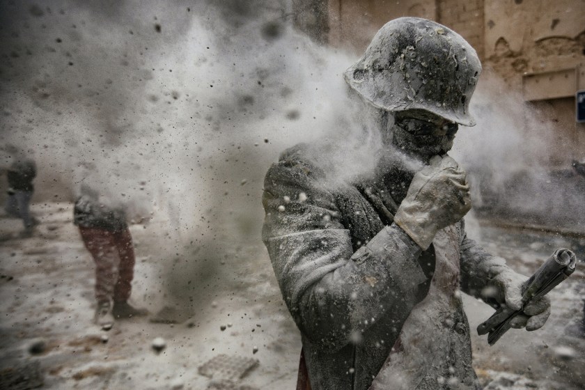 People - Second Prize, Stories: On 28 December each year, the “Floured War" takes place in Ibi in the province of Alicante, Spain. During the festival, the citizens are divided into two groups: the 'Enfarinat' (the floured) group simulates a coup d'etat and a second group tries to calm the rebellion. The teams play with flour, water, eggs and colored smoke bombs. The 200-year-old tradition is known as “Els Enfarinats”, marking the biblical Massacre of the Innocents by King Herod. (Antonio Gibotta/Agenzia Controluce)