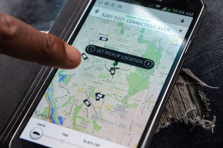 An UberX driver, Michael Belet checks the app. (Evelyn Hockstein/For The Washington Post via Getty Images)