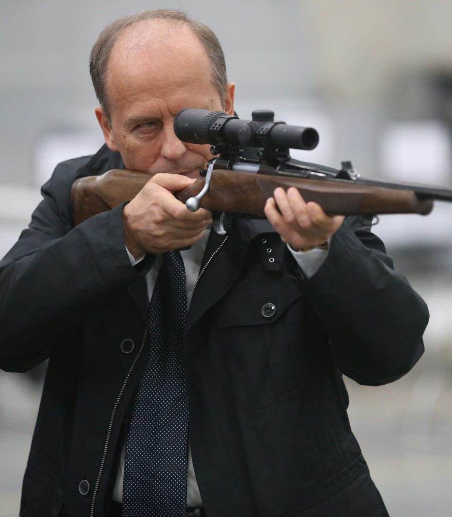 Russian Federal Security Service (FSB) Chief Alexander Bortnikov holds a gun-machine while visiting the Kalashnikov concern (Mikhail Svetlov/Getty Images)