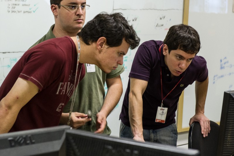 Workers discuss on a computer at Brazilian outsourcing company Ci&T in Campinas, about 100 km north from Sao Paulo, Brazil (YASUYOSHI CHIBA/AFP/GettyImages) 