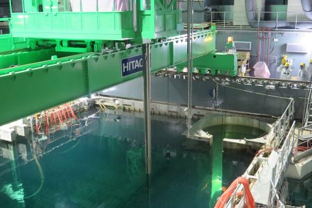 In this handout image provided by Tokyo Electric Power Co, workers remove nuclear fuel rods from a pool at No. 4 reactor of the Fukushima Daiichi Nuclear Power Plant on November 18, 2013 in Okuma, Fukushima, Japan.  TEPCO started removing nuclear fuel from a damaged reactor building for the first time, marking a new stage in the decades-long decommissioning process. The operation to empty the storage pool in the No. 4 reactor building, which holds 1,533 nuclear fuel assemblies, began and expected to be removed by December 2014. But the overall decommissioning work at the stricken nuclear plant is expected to take 30 to 40 years to complete.  (Tokyo Electric Power Co via Getty Images)