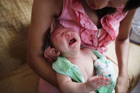 Mother Daniele Santos changes her baby Juan Pedro, 2-months-old, who was born with microcephaly, on February 3, 2016 in Recife, Pernambuco state, Brazil. In the last four months, authorities have recorded thousands of cases in Brazil in which the mosquito-borne Zika virus may have led to microcephaly in infants. Microcephaly results in an abnormally small head in newborns and is associated with various disorders. The state with the most cases is Pernambuco, whose capital is Recife, and is being called the epicenter of the outbreak.  (Photo by Mario Tama/Getty Images)