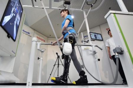 A model demonstrates how the rehabilitation-assist robot Welwalk WW-1000, developed by Japan's Toyota Motor Corporation, helps to assist in flexing and extending the knee while walking on a treadmill during a press preview in Tokyo on April 12, 2017.
(Kazuhiro Nogi/AFP/Getty Images)