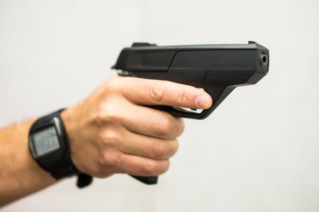 A person is holding an Armatix iP1-Pistole and wearing the watch to unlock the gun on July 11, 2014 at a shooting range at the headquarters of Armatix in Unterfoehring, near Munich, Germany.  (Sebastian Widmann for The Washington Post via Getty Images)