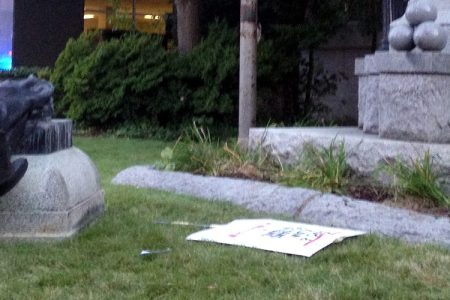 A toppled Confederate statue lies on the ground