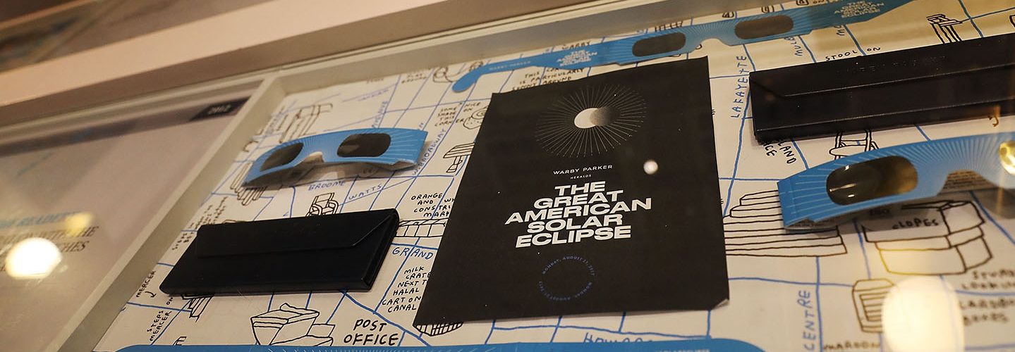 Pairs of free solar eclipse glasses sit on display at a Warby Parker store on August 11, 2017 in New York City.