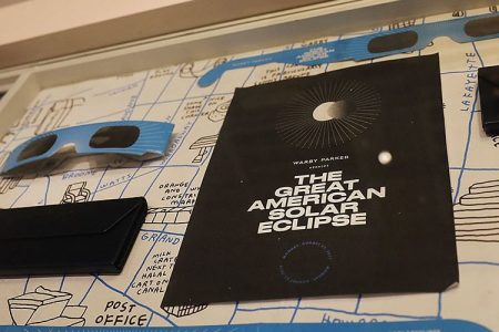 Pairs of free solar eclipse glasses sit on display at a Warby Parker store on August 11, 2017 in New York City.