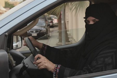 a woman drives a car in Riyadh, Saudi Arabia