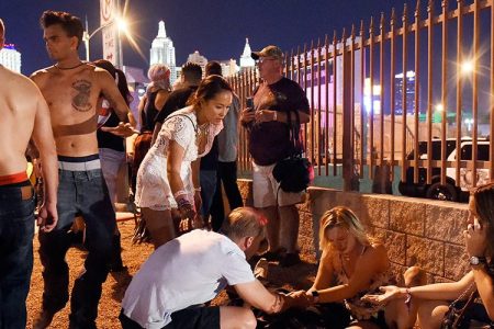 People tend to the wounded outside the Route 91 Harvest Country music festival grounds after an apparent shooting on October 1, 2017 in Las Vegas, Nevada. There are reports of an active shooter around the Mandalay Bay Resort and Casino. (Photo by David Becker/Getty Images)