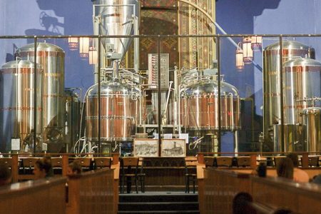 Beer brewing tanks sit at the former altar of The Church Brew Works, an old church renovated into a brewery, in Pittsburgh.  (AP Photo/Dake Kang)