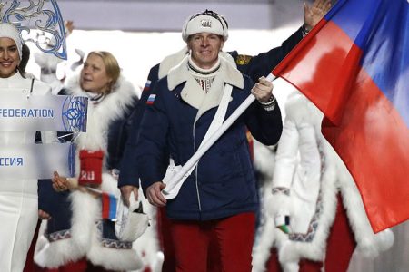 Alexander Zubkov of Russia carries the national flag as he leads the team during the opening ceremony of the 2014 Winter Olympics in Sochi, Russia. (AP Photo/Mark Humphrey, file)