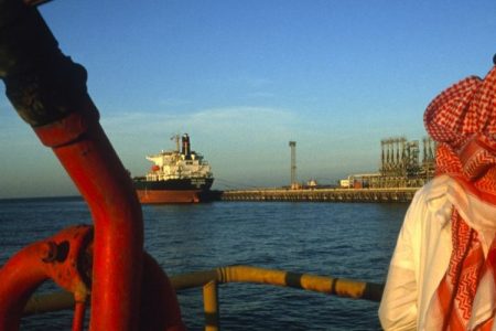 A man stands on a platform on an oil and gas terminal on January 2003 in n the Persian Gulf off of Ras Al Tanoura, Saudi Arabia. (Reza/Getty Images)