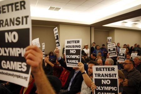 Signs protesting the Olympics being held in Boston during a Community Meeting at Suffolk Law School in Boston, Massachusetts February 5, 2015. (Jessica Rinaldi/The Boston Globe via Getty Images)