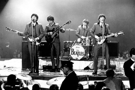 The Beatles perform onstage at the Washington Coliseum on February 11, 1964 in Washington, D.C.   (Photo by Michael Ochs Archives/Getty Images)