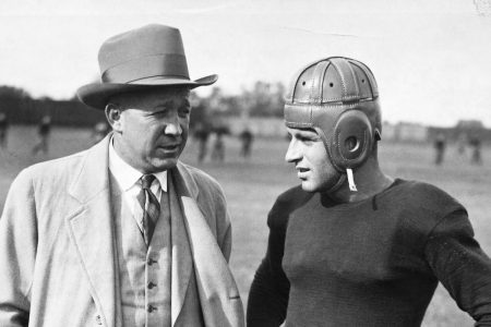 Notre Dame football coach Knute Rockne talks with a player. (George Rinhart/Corbis via Getty Images)