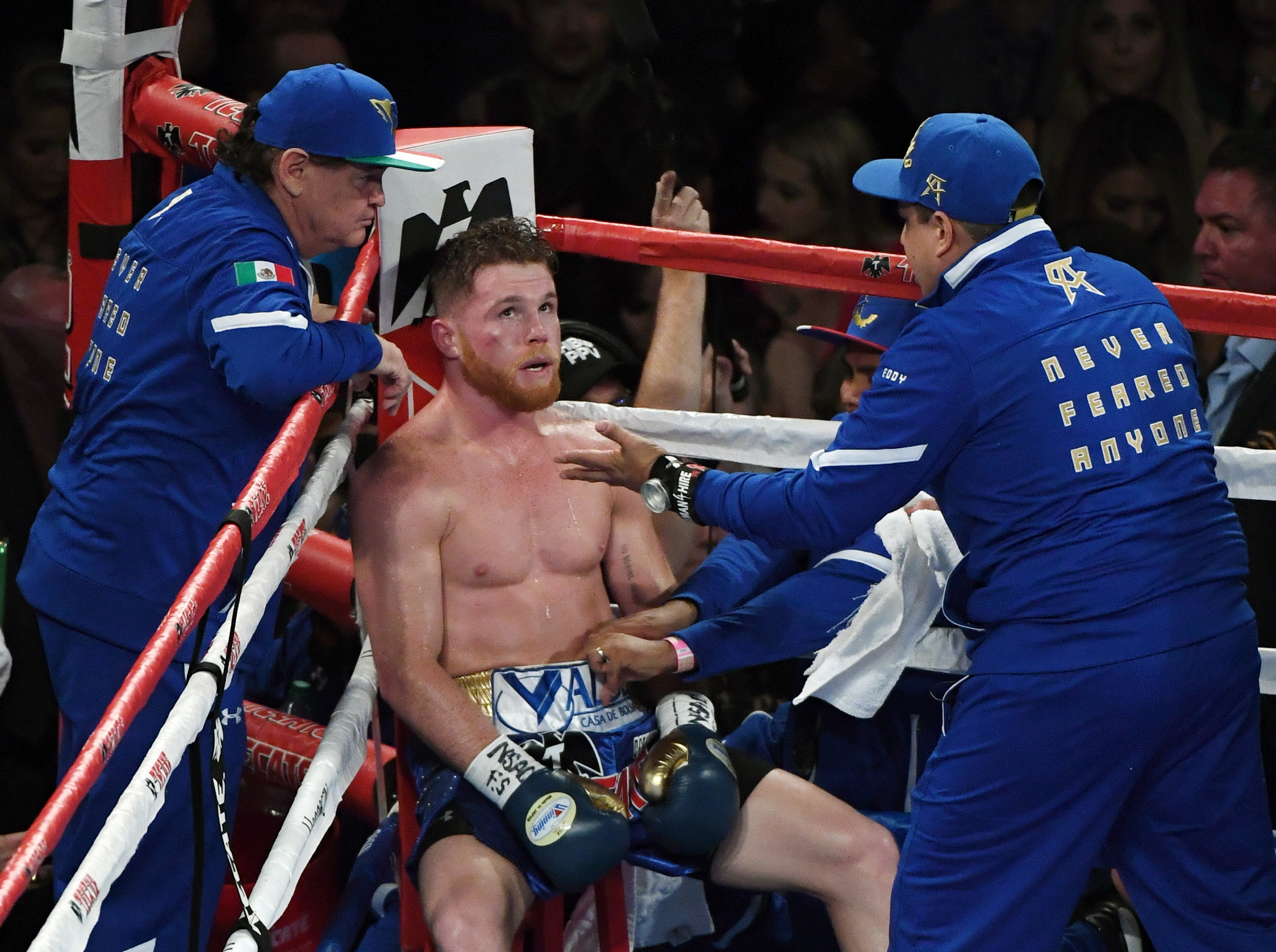 LAS VEGAS, NV - SEPTEMBER 16:  Manager/trainer Jose "Chepo" Reynoso (L) and trainer Eddy Reynoso (R) talk with Canelo Alvarez (C) in his corner after the fifth round of his WBC, WBA and IBF middleweight championship bout against Gennady Golovkin at T-Mobile Arena on September 16, 2017 in Las Vegas, Nevada. The boxers fought to a draw and Golovkin retained his titles.  (Photo by Ethan Miller/Getty Images)