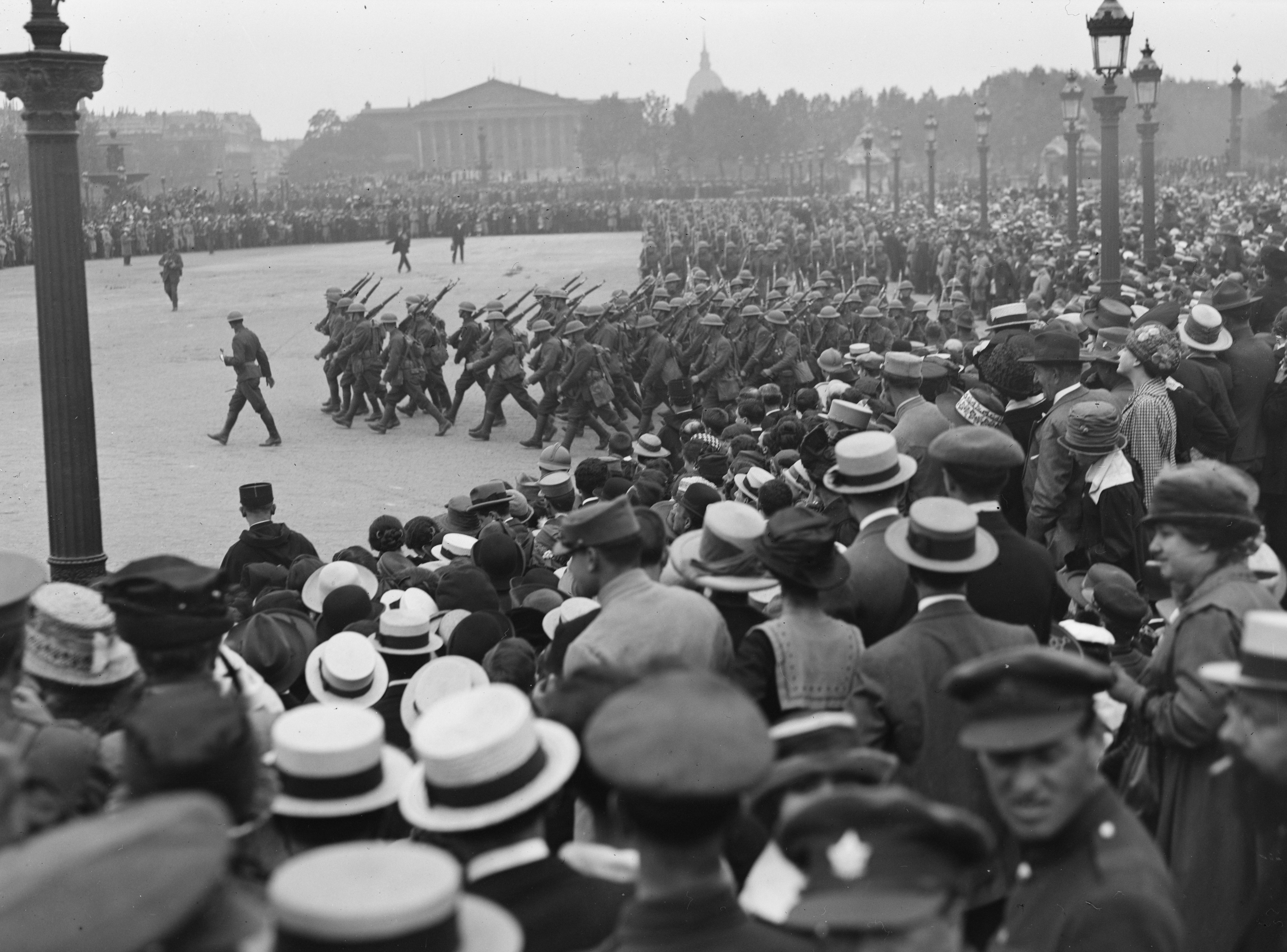 View over the crowd as they watch American troops march in the Place de la Concorde during a parade in celebration of US independence, Paris, France, July 4, 1918. (Lewis Hine/Interim Archives/Getty Images)