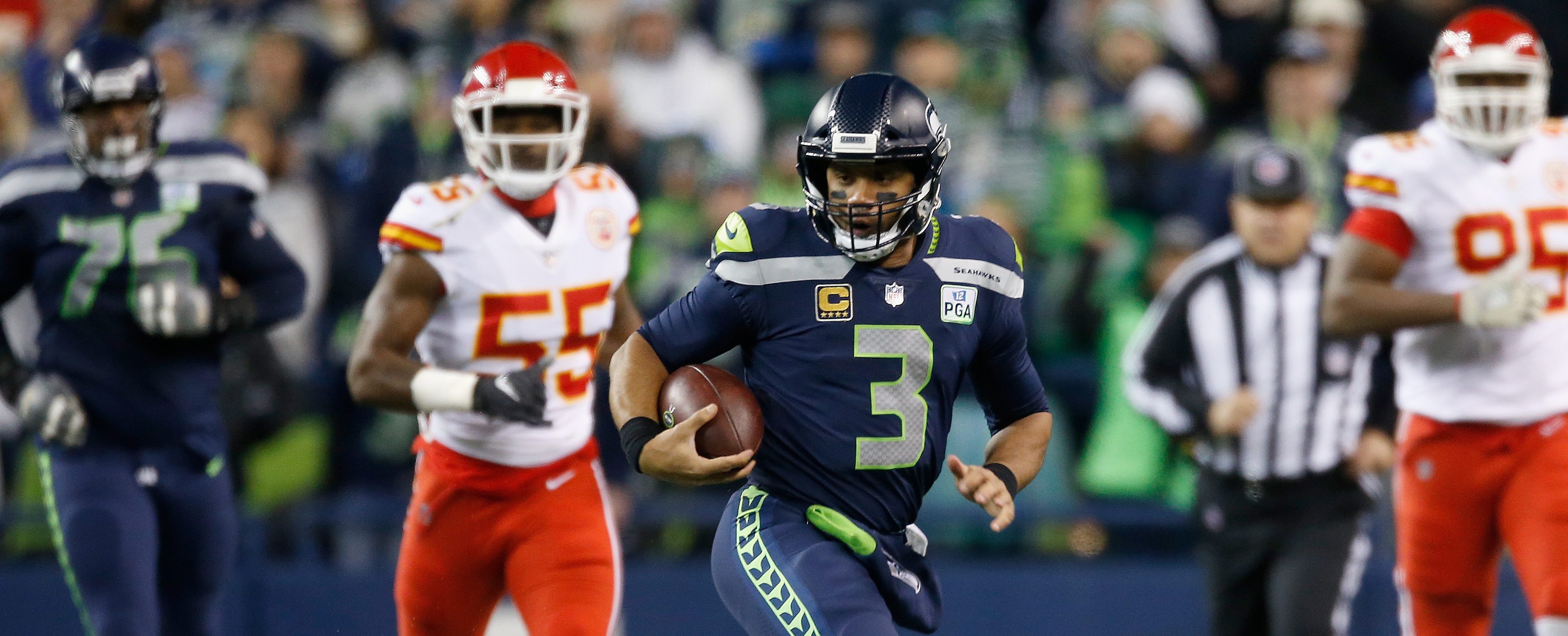 Quarterback Russell Wilson #3 of the Seattle Seahawks rushes for a first down during the first quarter of the game against the Kansas City Chiefs at CenturyLink Field on December 23, 2018 in Seattle, Washington.  (Photo by Otto Greule Jr/Getty Images)