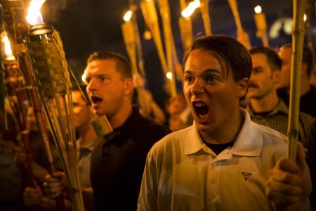 Peter Cvjetanovic (R) along with Neo Nazis, Alt-Right, and White Supremacists encircle and chant at counter protestors at the base of a statue of Thomas Jefferson after marching through the University of Virginia campus with torches in Charlottesville, Va., USA on August 11, 2017. (Photo by Samuel Corum/Anadolu Agency/Getty Images)