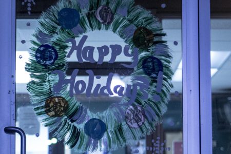 The Town of Linden's City Hall had a lit up sign wishing a "Merry Christmas" while the front door had a hand drawn "Happy Holidays" decorating it.  (Andrea Morales for The Washington Post via Getty Images)